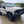 Load image into Gallery viewer, White off-road vehicle with roof rack on a wet driveway
